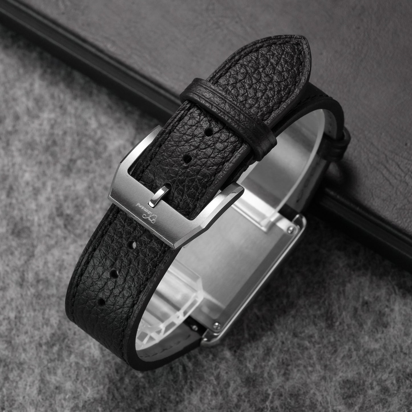 Close-up of black pebbled leather watch strap fitted to a dress watch