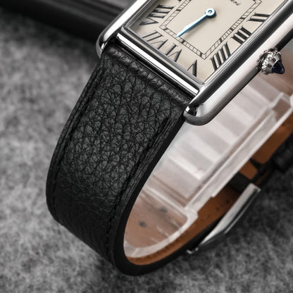 Black pebbled leather watch strap paired with a rectangular dress watch