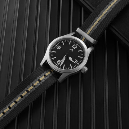 Black striped nylon NATO strap fitted to a field watch